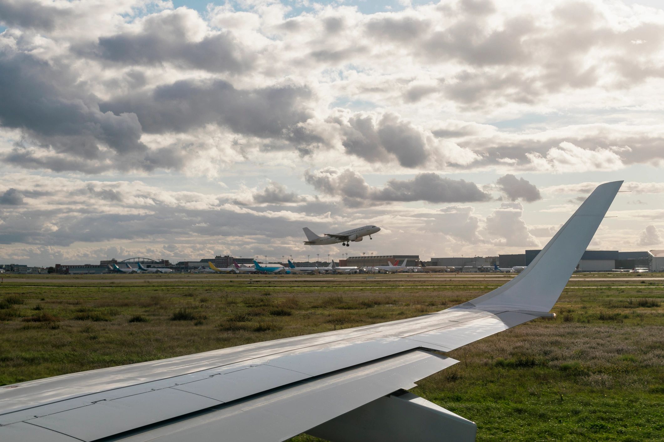 Airplane wing and runway at an airport