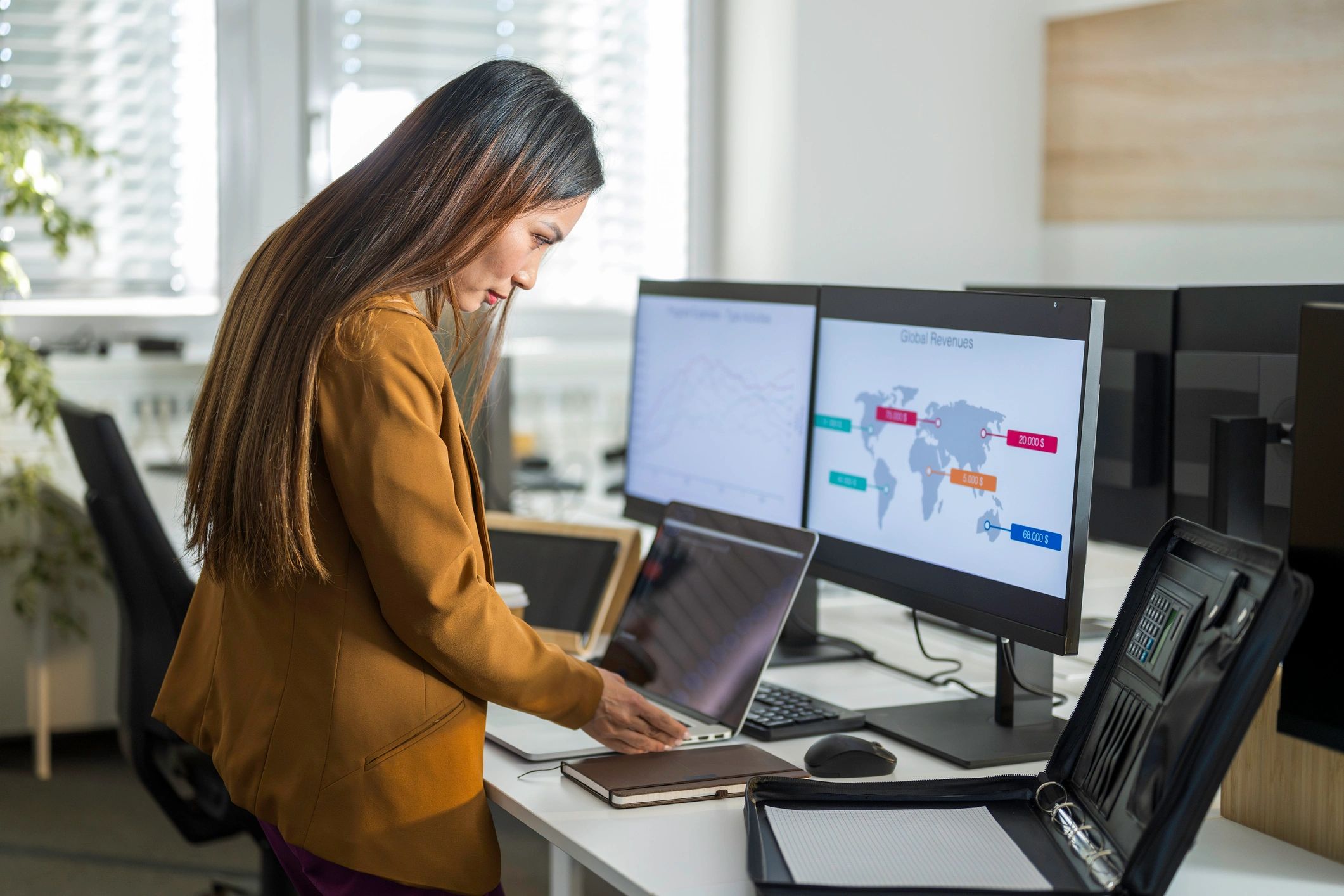 Travel consultant planning an itinerary on a laptop