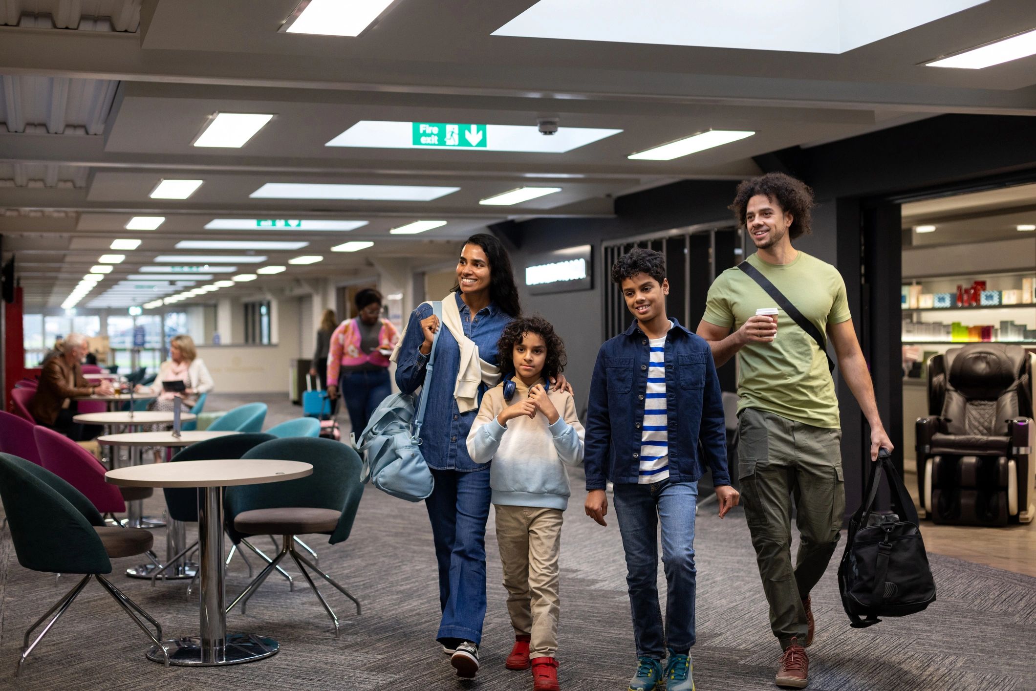 Family walking through an airport with luggage
