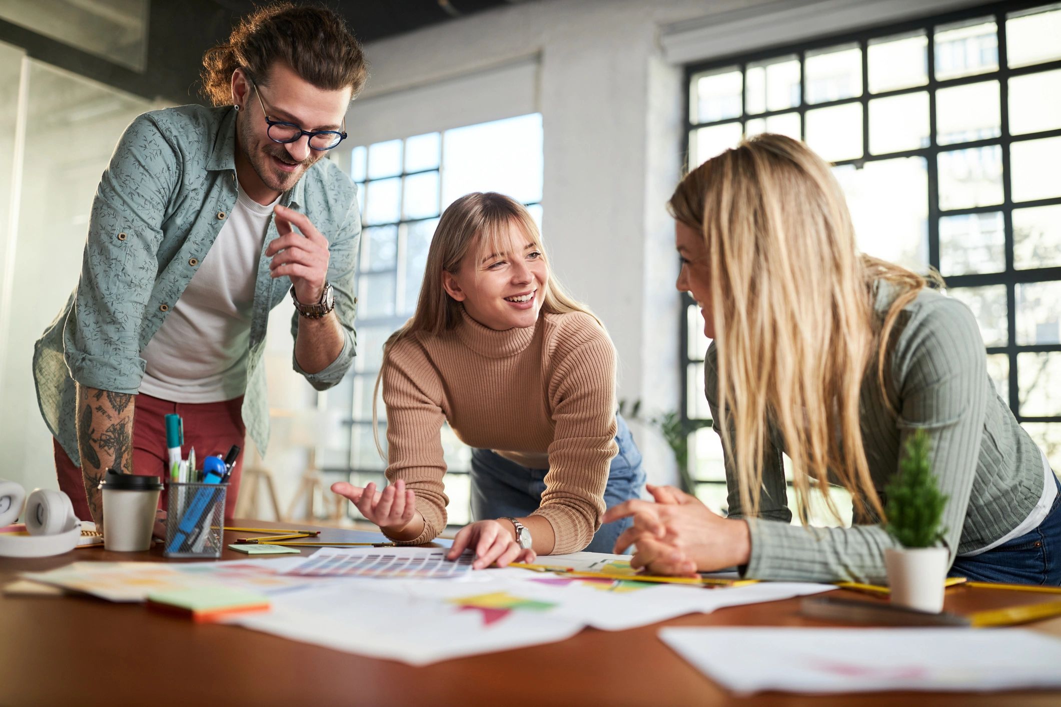 Travel planning team reviewing documents and itinerary notes