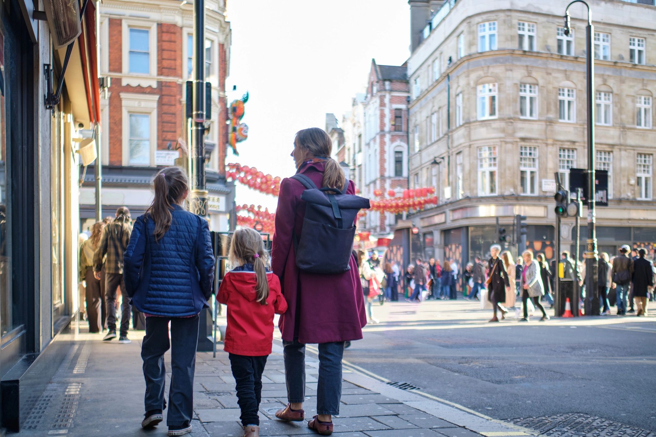 Family walking together on a city street during a trip