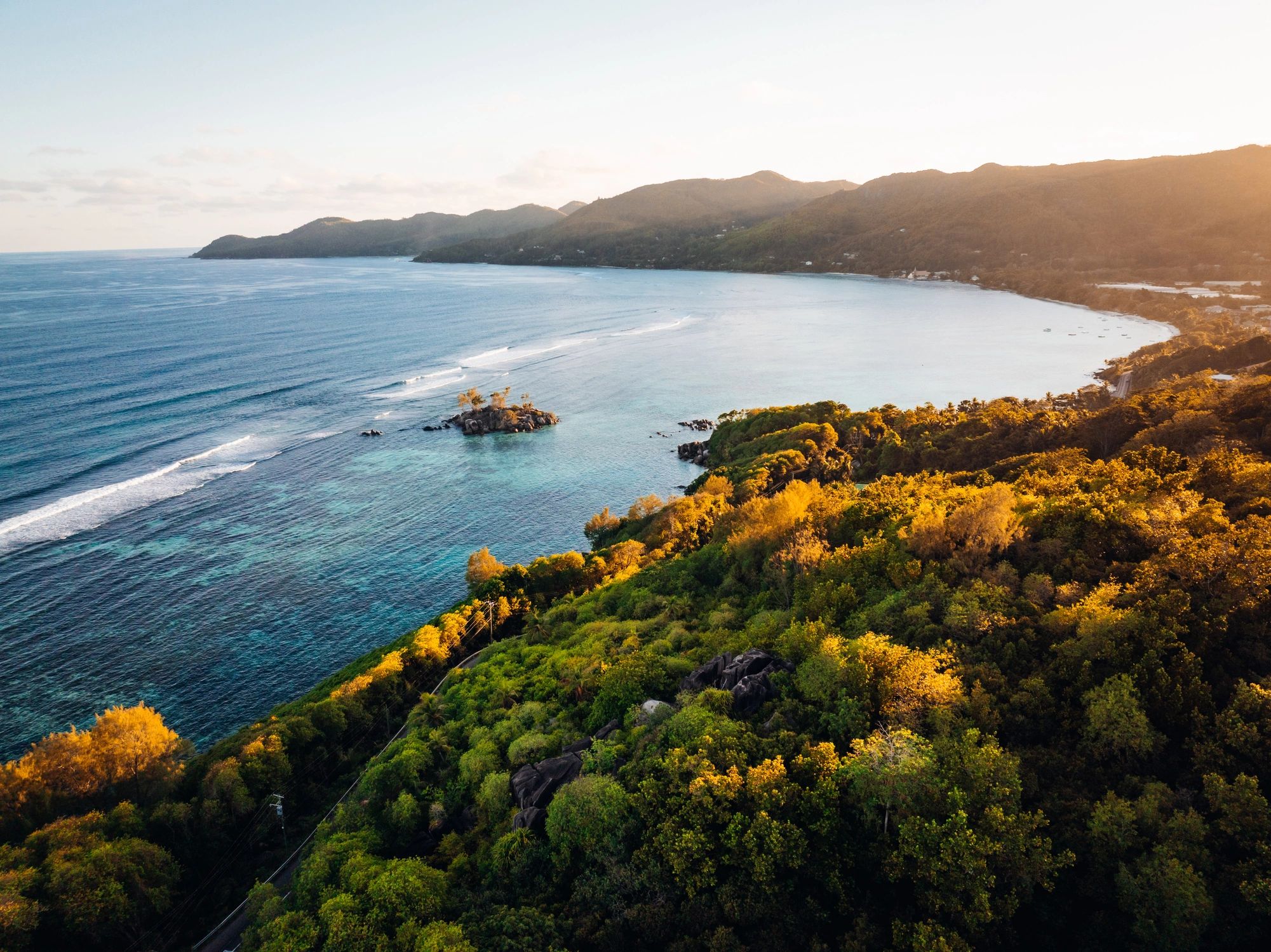 Aerial view of a tropical coastline at sunset