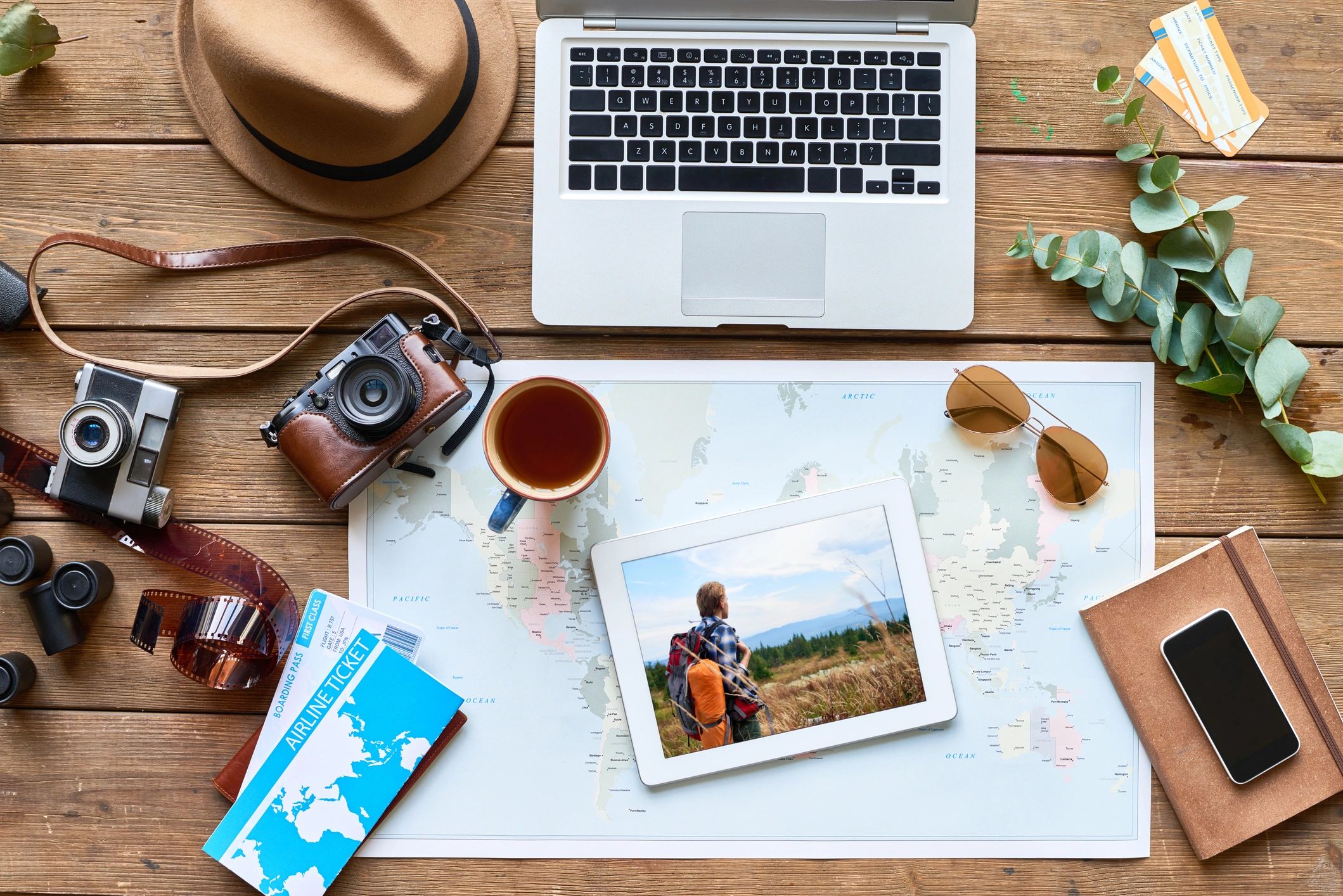 Flat lay of travel planning tools including map and tickets